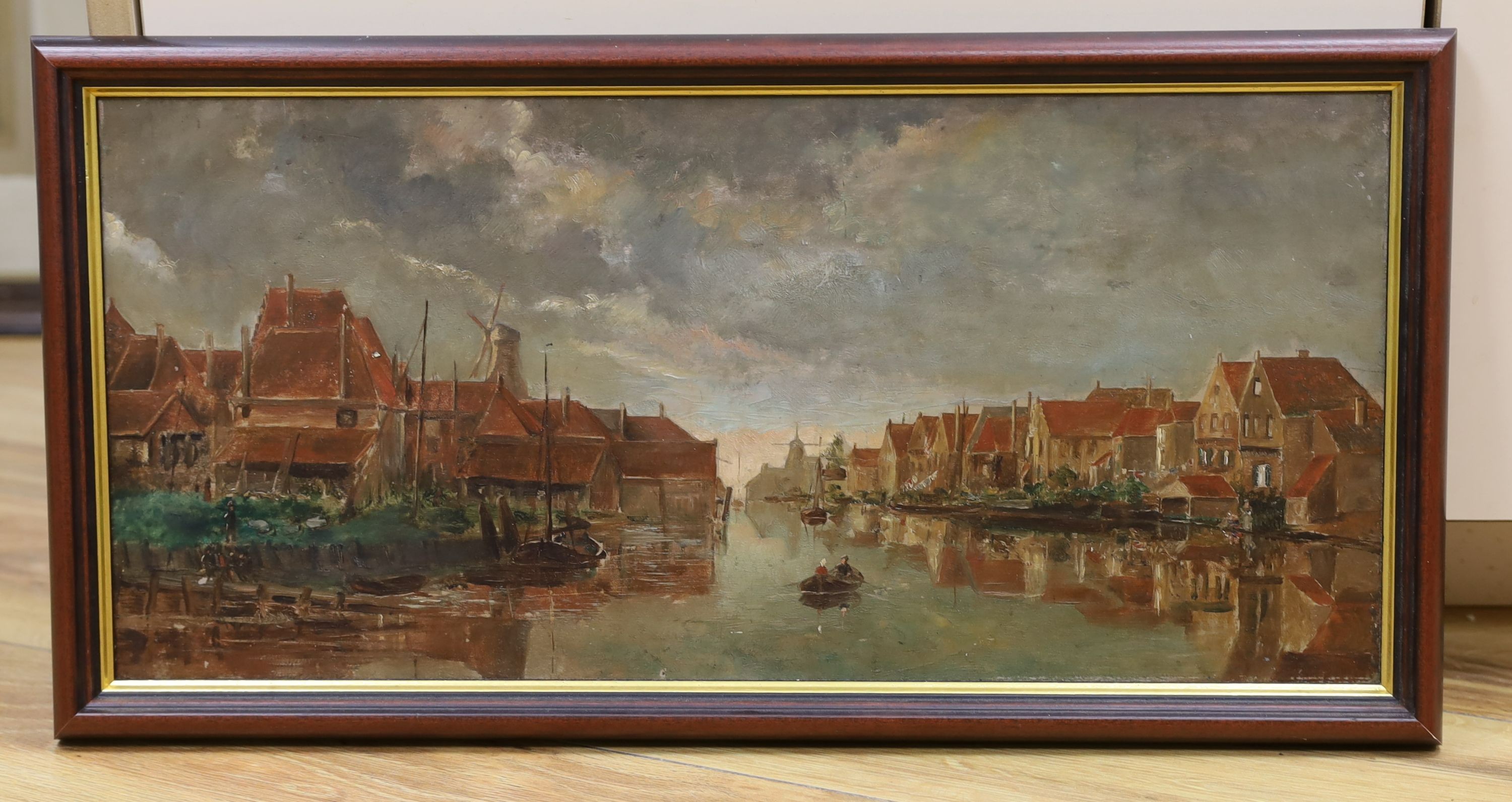 Dutch School c.1900, oil on wooden panel, View of a waterside town, 23 x 50cm